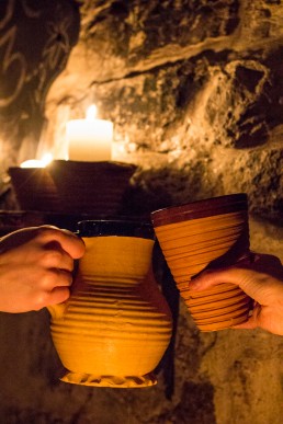 Drinks from clay mugs at a medieval bar Draakon in Old Town, Tallinn