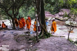 Monks at the waterfall in Bokor Hill Station, Cambodia