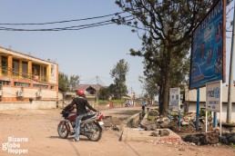 A moto-taxi driver waits for clients on the outskirts of Goma, Democratic Republic of the Congo.