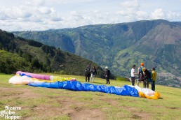 Team making preparations just before taking off to paraglide in Medellin, Colombia