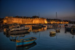 The harbor of Kalkara Bay at night in Malta.